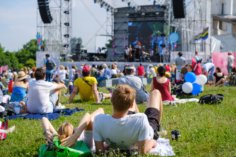 Photo of people relaxing in the grass at Bear Shadow Festival in Highlands, NC